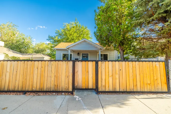 Wood privacy fence with metal framing and gate
