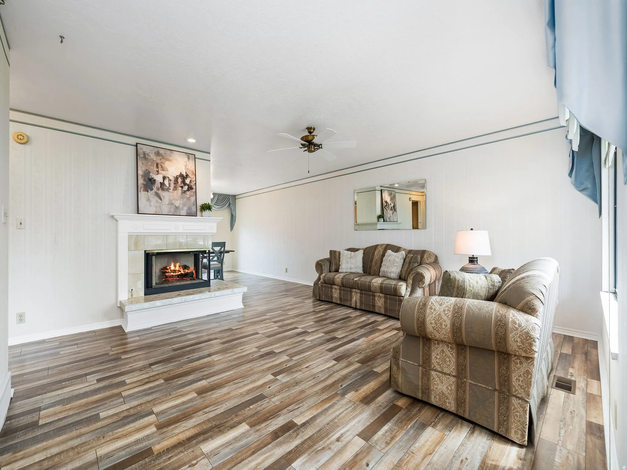 Fireplace with a mantel, tile hearth, and surround