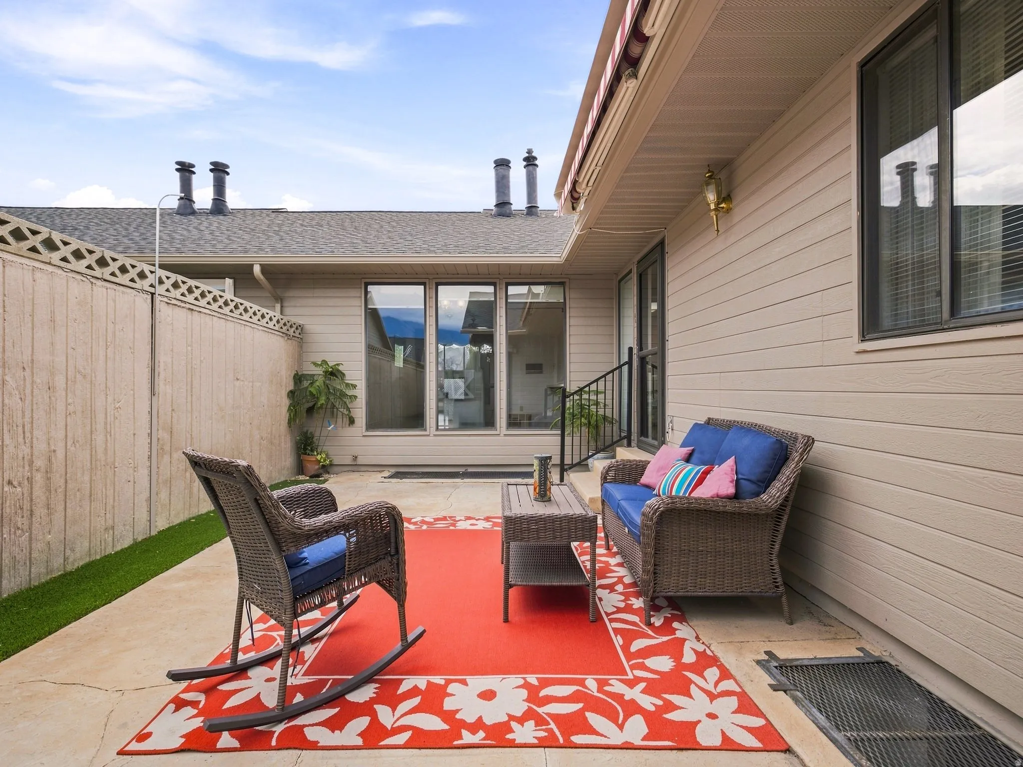 Outdoor patio with concrete surfacing, siding exterior, and a privacy fence