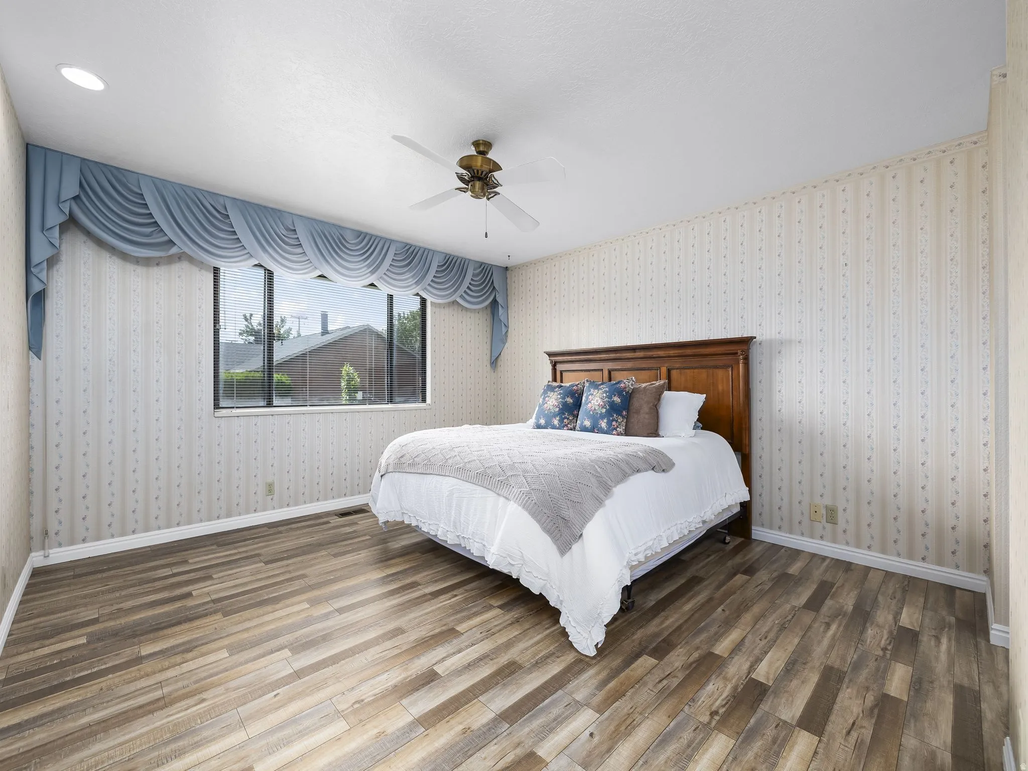 Wood-finish flooring, recessed ceiling lighting, and a ceiling fan