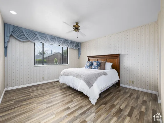 Wood-finish flooring, recessed ceiling lighting, and a ceiling fan