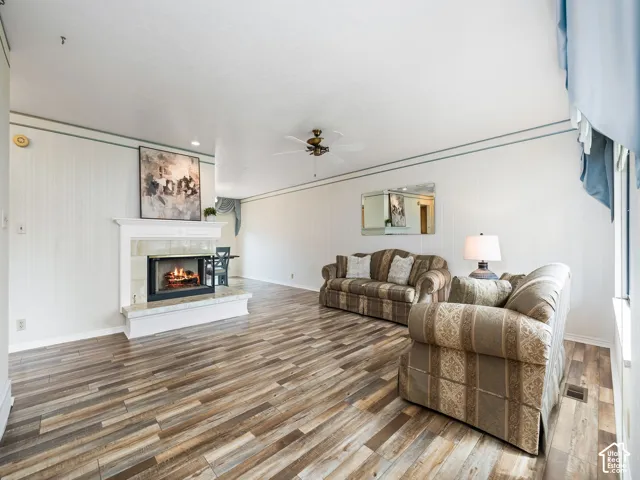 Fireplace with a mantel, tile hearth, and surround
