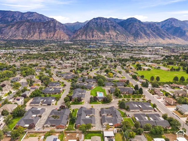 Expansive neighborhood featuring residential properties, mature trees, and a community pool