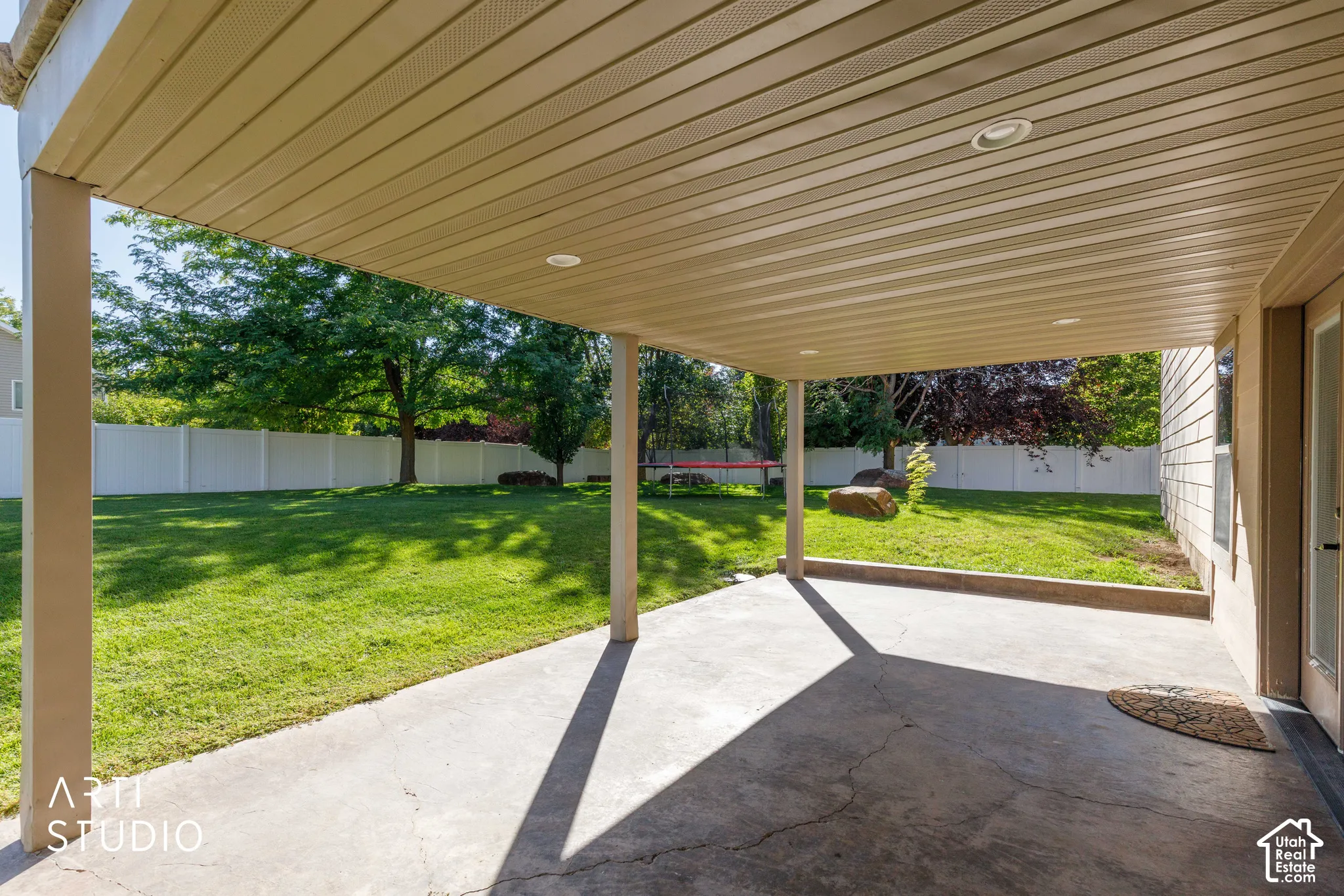 Covered patio with recessed lighting and concrete flooring