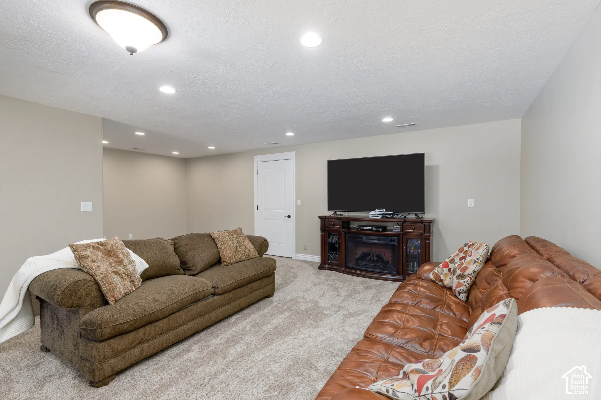 Neutral-toned walls complement the light-colored carpet flooring