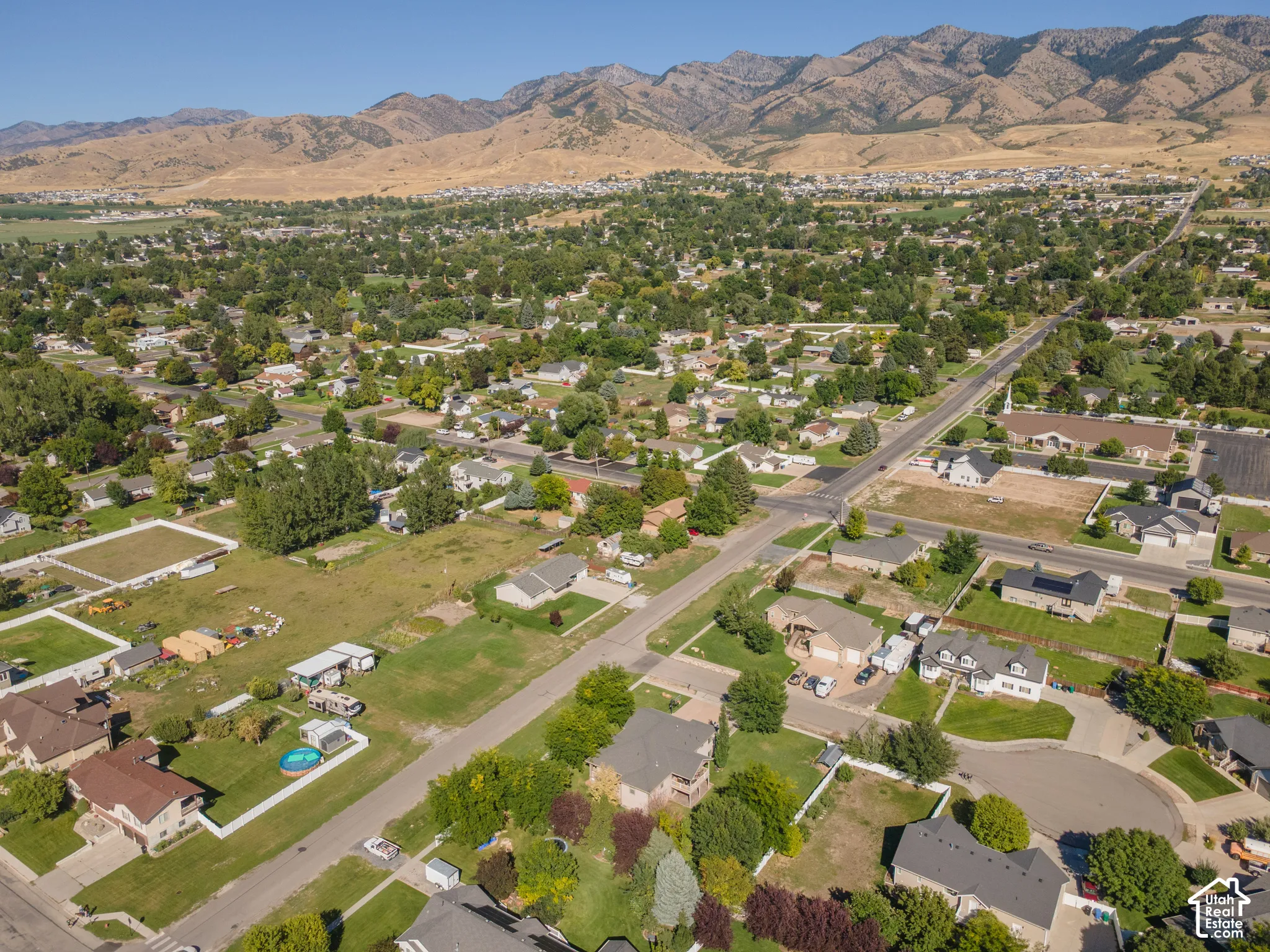 Mountain backdrop, established neighborhood, residential streets, mature trees, single-family residences