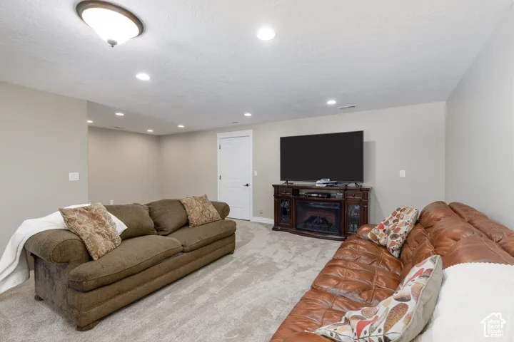 Neutral-toned walls complement the light-colored carpet flooring