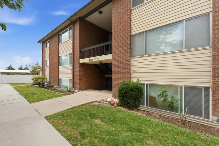 Brick and siding exterior with concrete walkways and landscaping