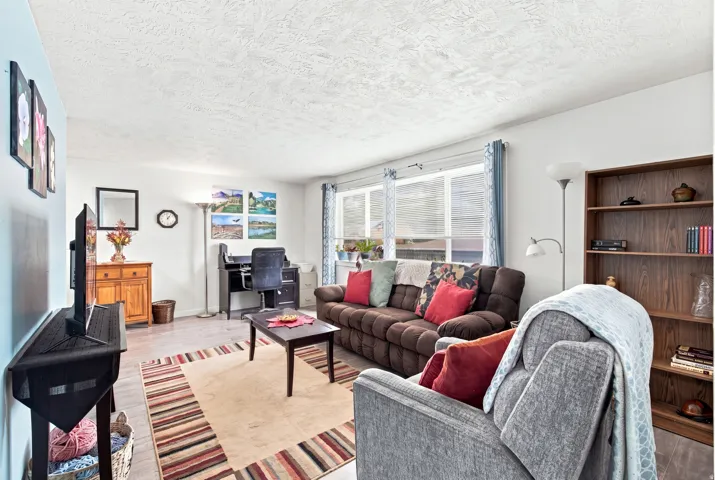Expansive living area with newer flooring, and large windows