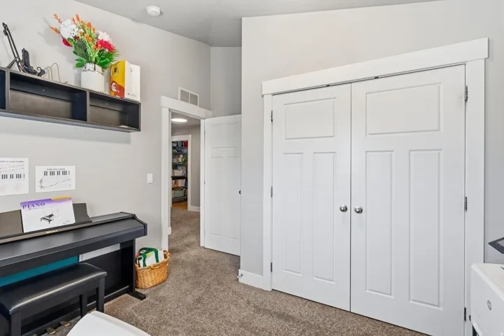 Carpeted flooring, white trim, and white doors