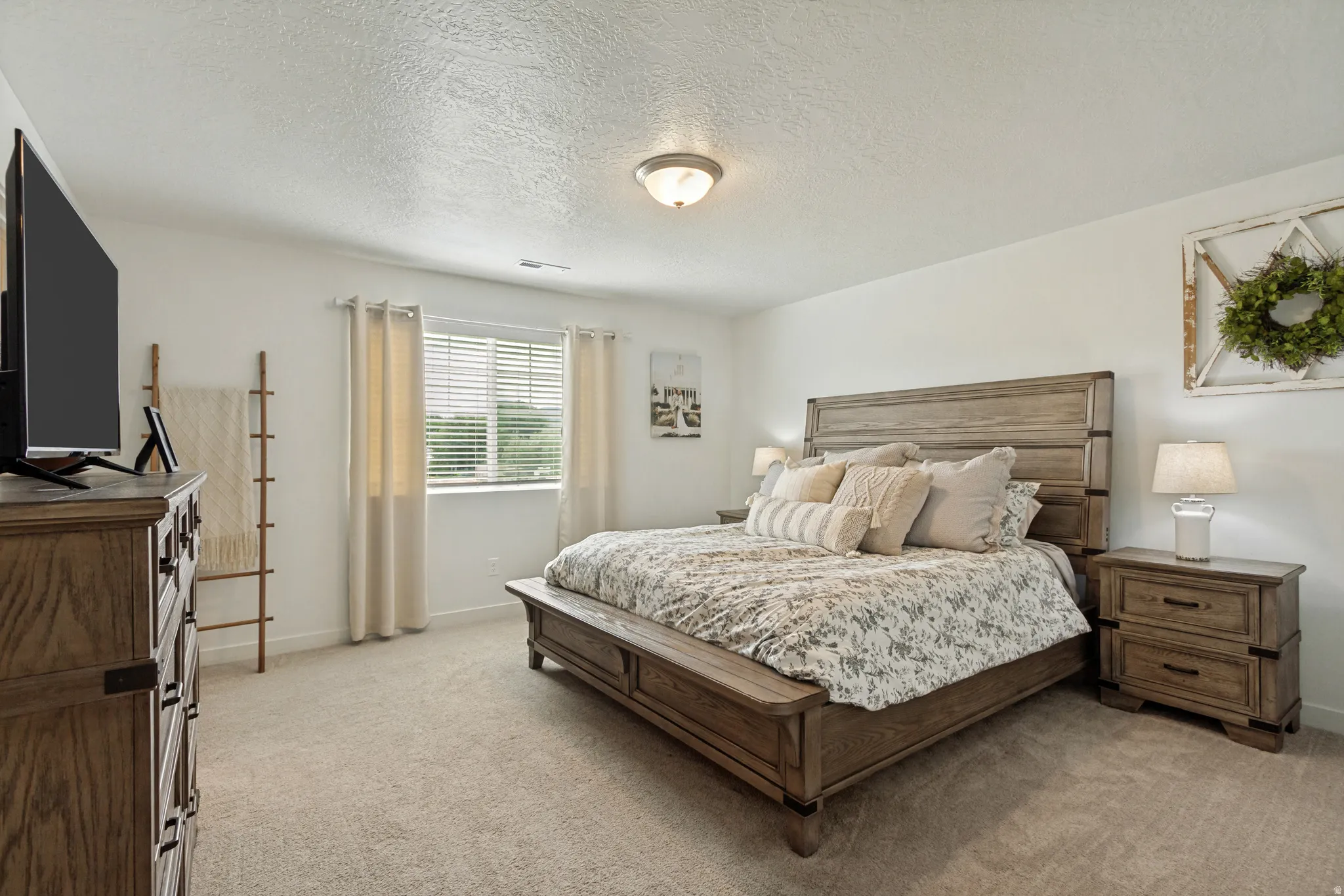 Neutral wall color, window with blinds, carpeted flooring, and a ceiling-mounted light fixture