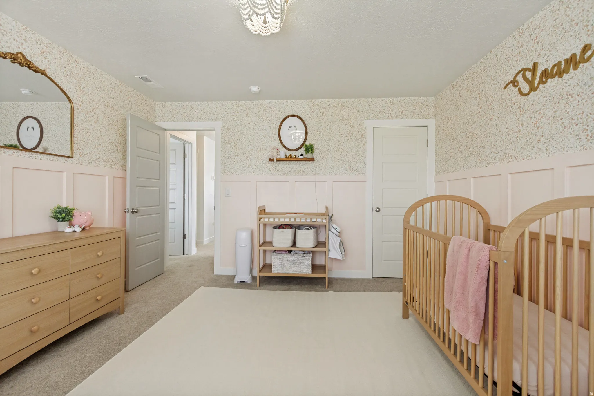 Wall-to-wall carpeting and decorative chandelier