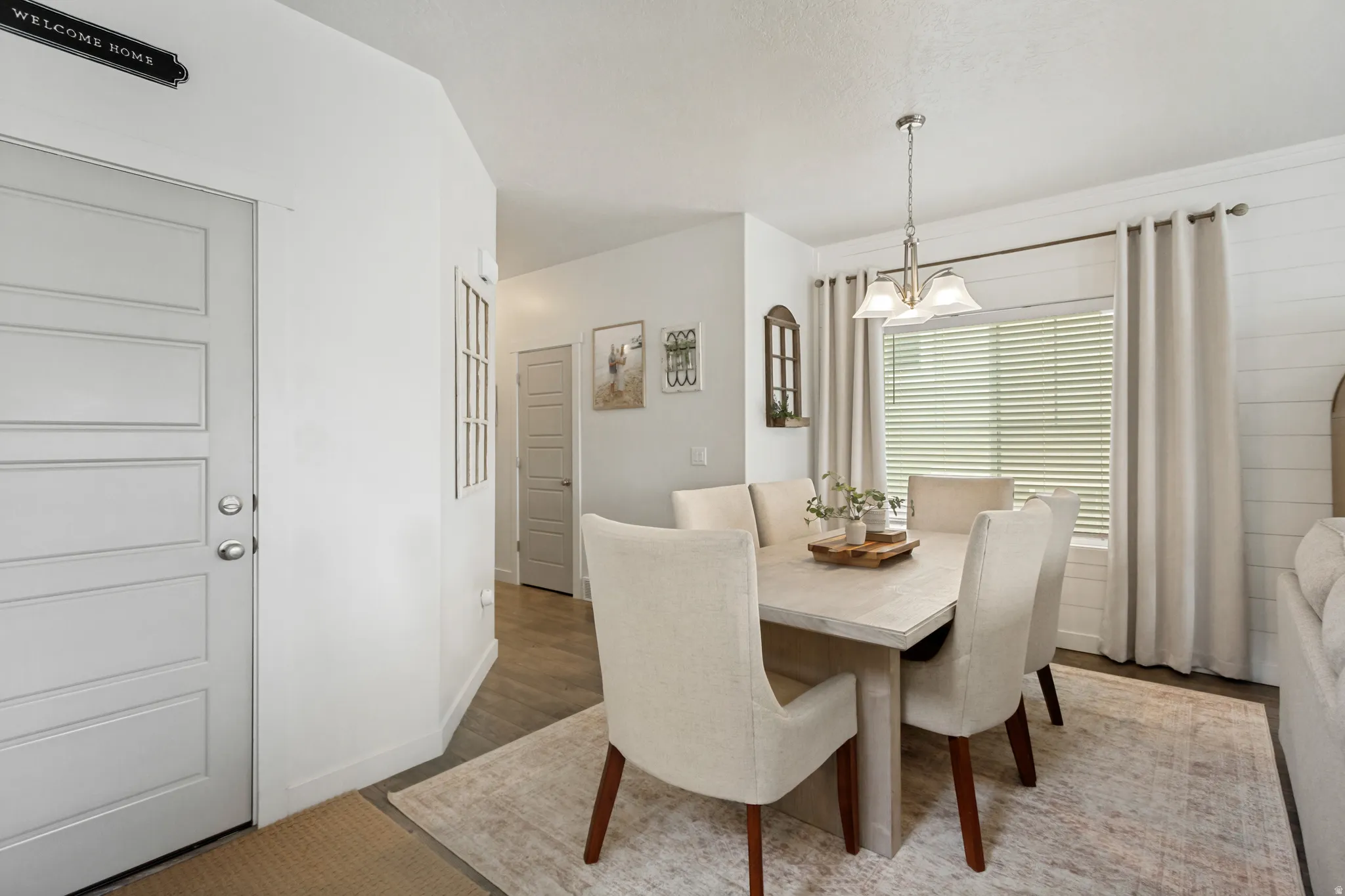 Recessed lighting, wood-finish flooring, and a contemporary light fixture