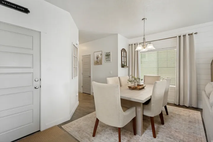 Recessed lighting, wood-finish flooring, and a contemporary light fixture
