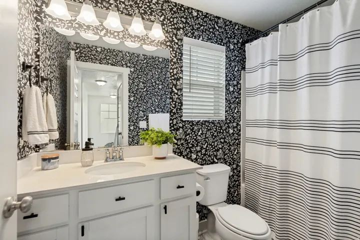 White vanity with an integrated sink and matte black hardware
