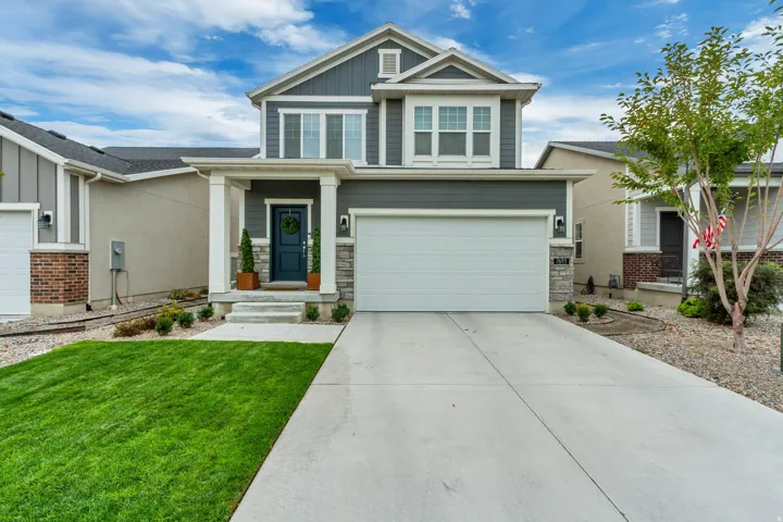 Two-story exterior with gray siding and stone accents