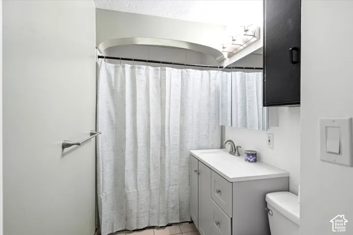 Light gray vanity with an integrated sink and brushed nickel faucet, complemented by a mirrored medicine cabinet