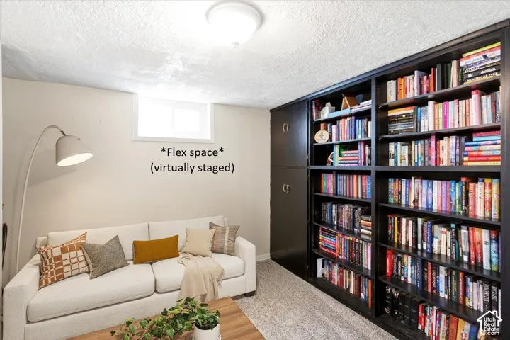 Built-in dark wood shelving and cabinetry, light-toned walls, and a small window