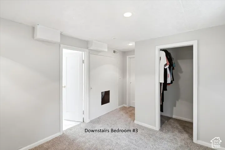 Plush carpeted flooring with recessed ceiling lighting, a built-in closet, and white interior doors