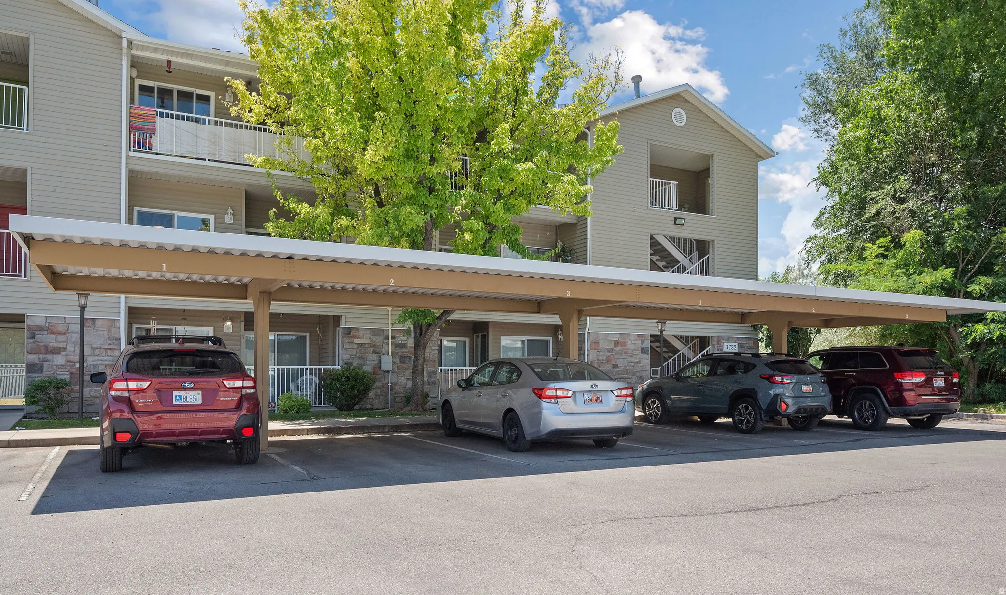 Multi-story residential building with siding and stone veneer accents