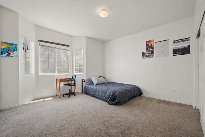 White walls with gray carpet flooring