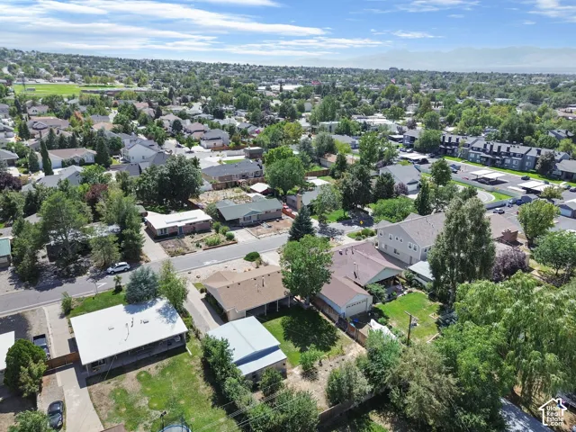 Residential neighborhood setting with mature tree canopies and distant mountain scenery