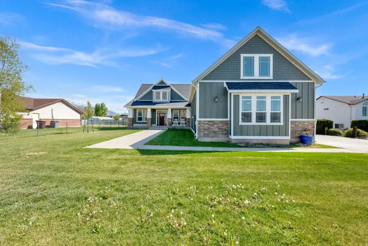 Two-story home with a gabled roofline and stone accent facade