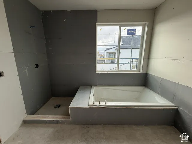 Bathtub installation with adjacent shower area, and an exterior window