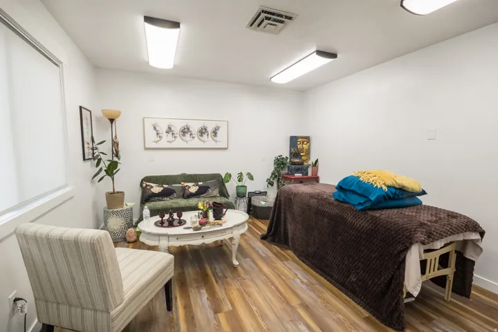 Bright interior space with wood-finish flooring, white walls, and contemporary overhead lighting