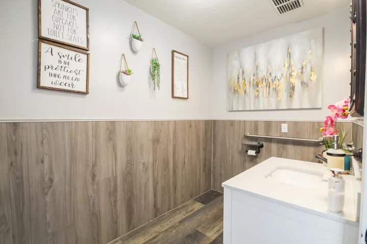 White vanity with an integrated sink and light-toned countertop