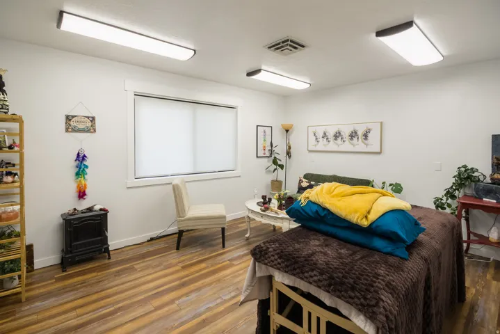 Wood-finish flooring, white walls, and recessed lighting fixtures