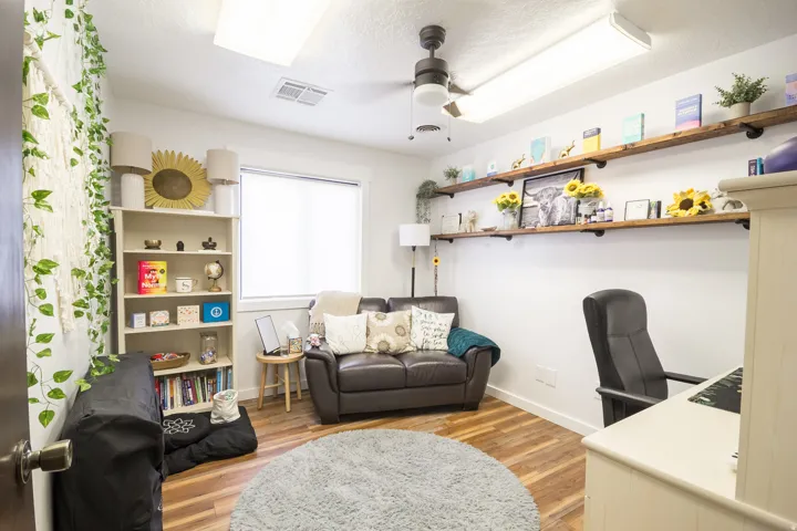 Wood-finish flooring, built-in shelving, ceiling fan, and recessed lighting