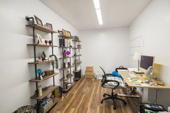Wood-finish flooring with white walls and a white ceiling