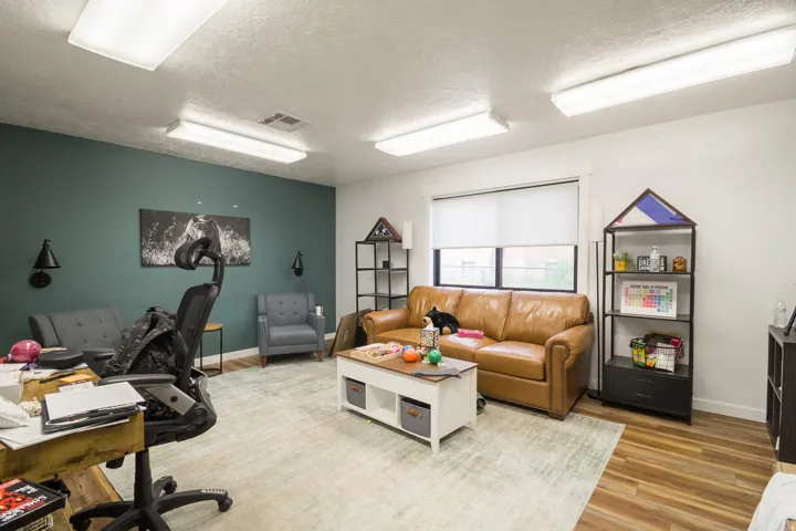 Wood-finish flooring, recessed lighting, and a window with roller shades