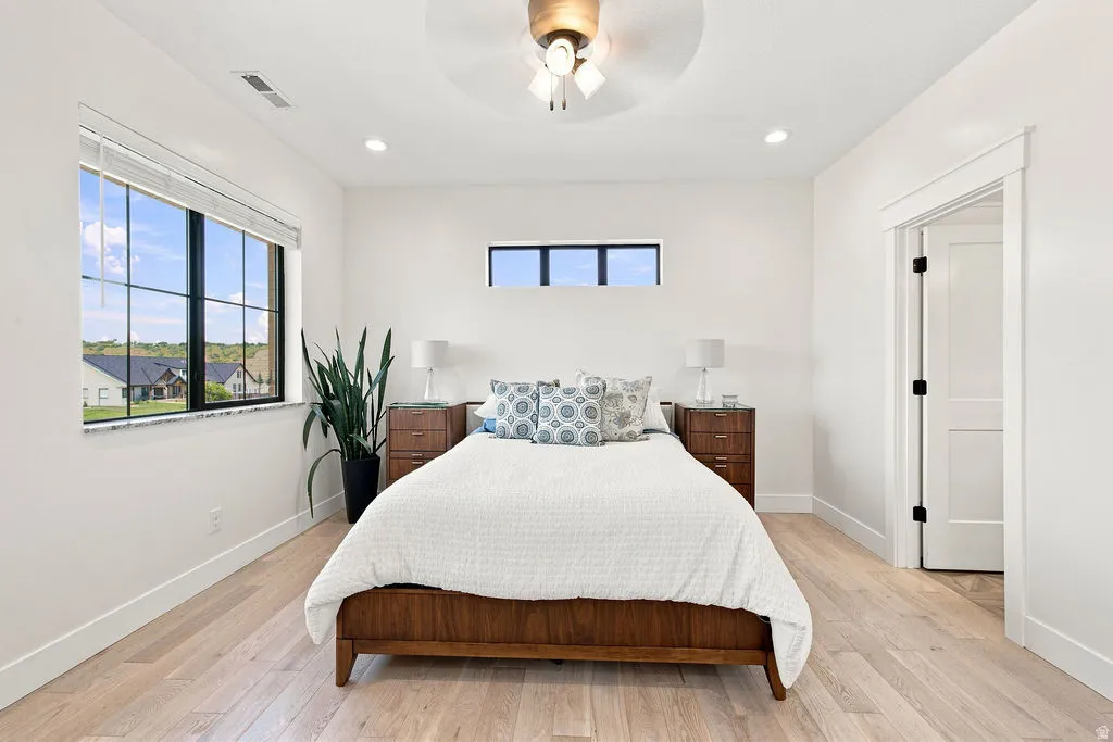 Light wood-finish flooring with white baseboards