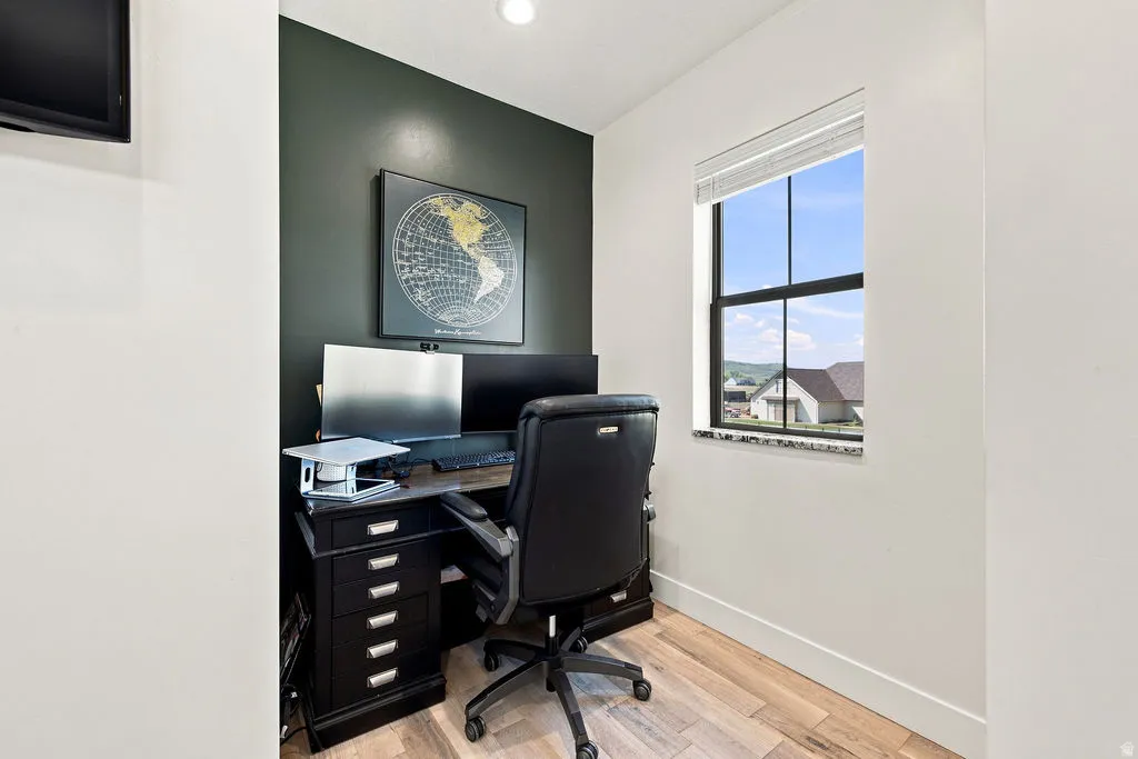 Natural light window, wood-finish flooring, two-tone wall paint, built-in ceiling lighting