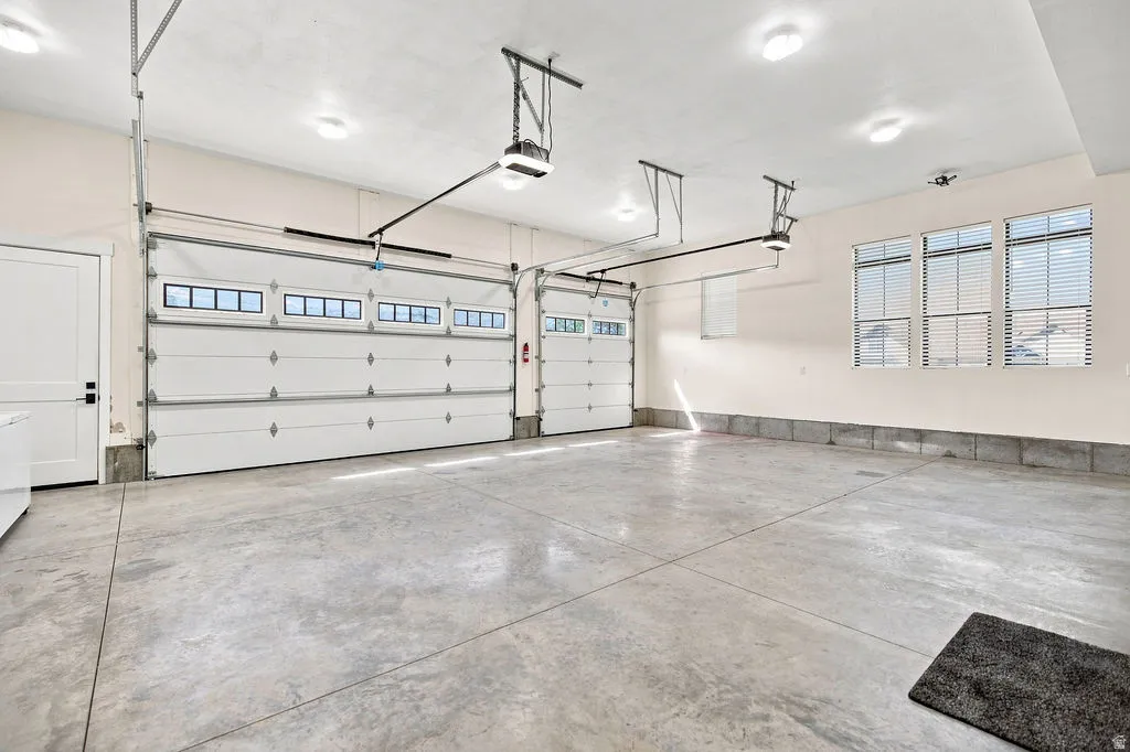 Two overhead garage doors with window panels