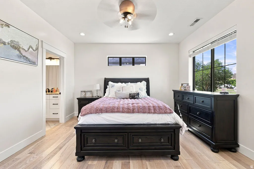 Light wood-finish flooring, recessed lighting, and a ceiling fan with integrated lighting