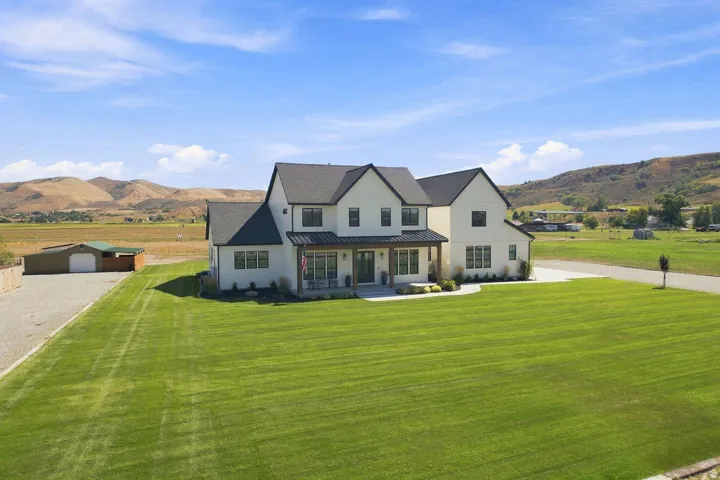 Two-story residence with a dark roof and light-colored siding