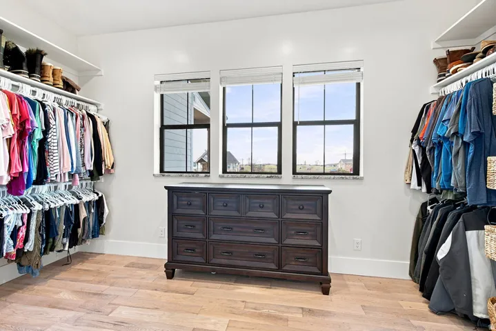 Custom closet system featuring built-in shelving and hanging rods