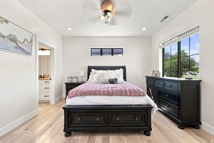 Light wood-finish flooring, recessed lighting, and a ceiling fan with integrated lighting