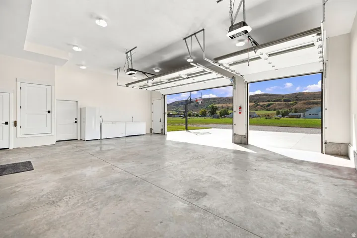 Spacious garage featuring a concrete floor, recessed lighting, and two automatic garage doors
