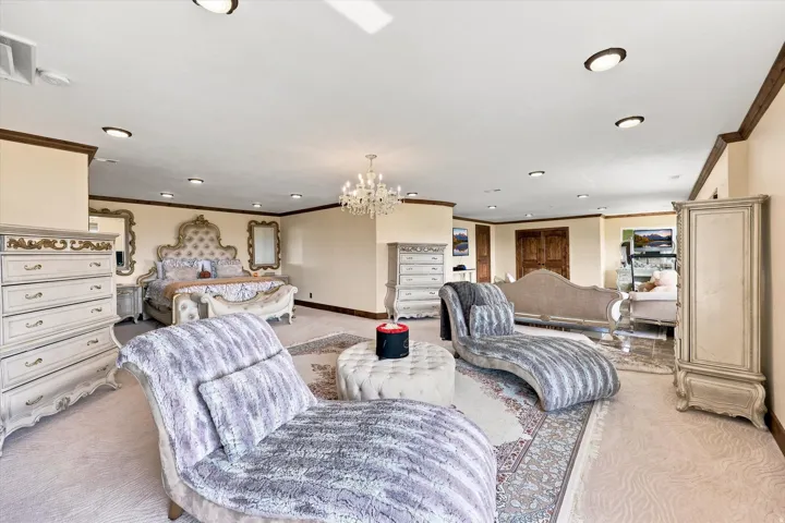 Recessed ceiling lighting, crown molding, double doors, chandelier, and a decorative ceiling fan