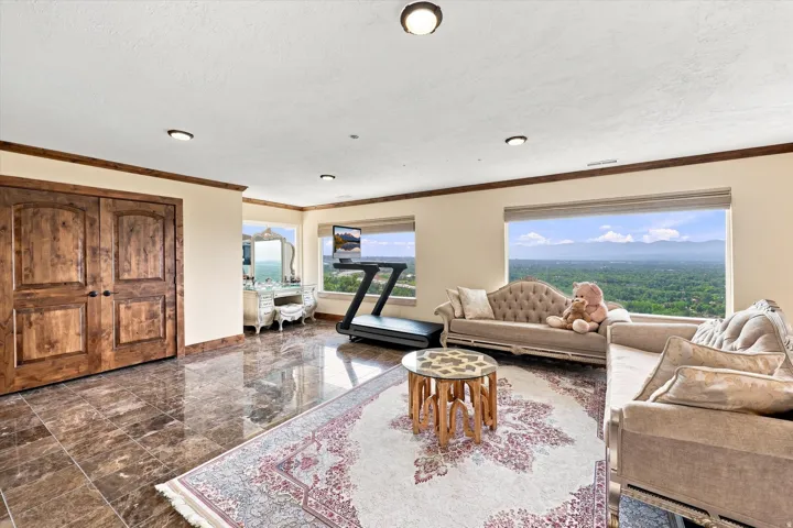Wood-finish double doors, large windows, recessed lighting, and tile flooring