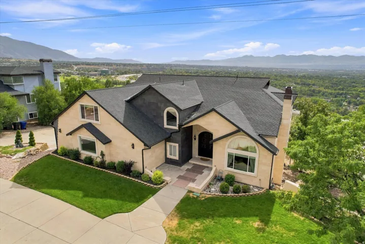 Stucco exterior with dark-toned roofing and decorative arched windows