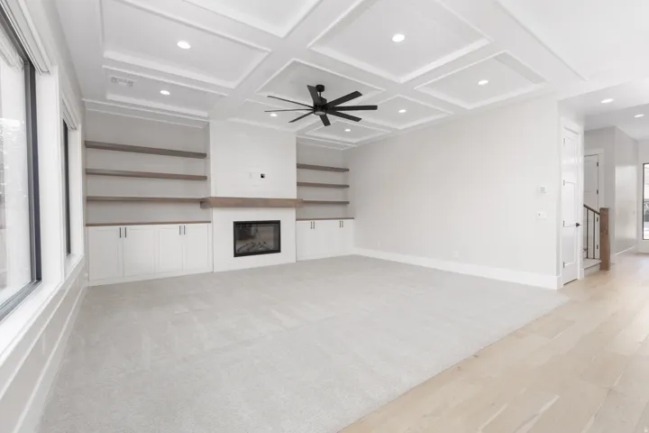 Coffered ceiling with recessed lighting and a ceiling fan