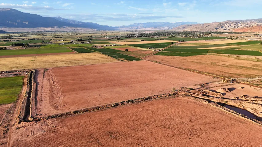 Expansive cleared land featuring distinct red soil