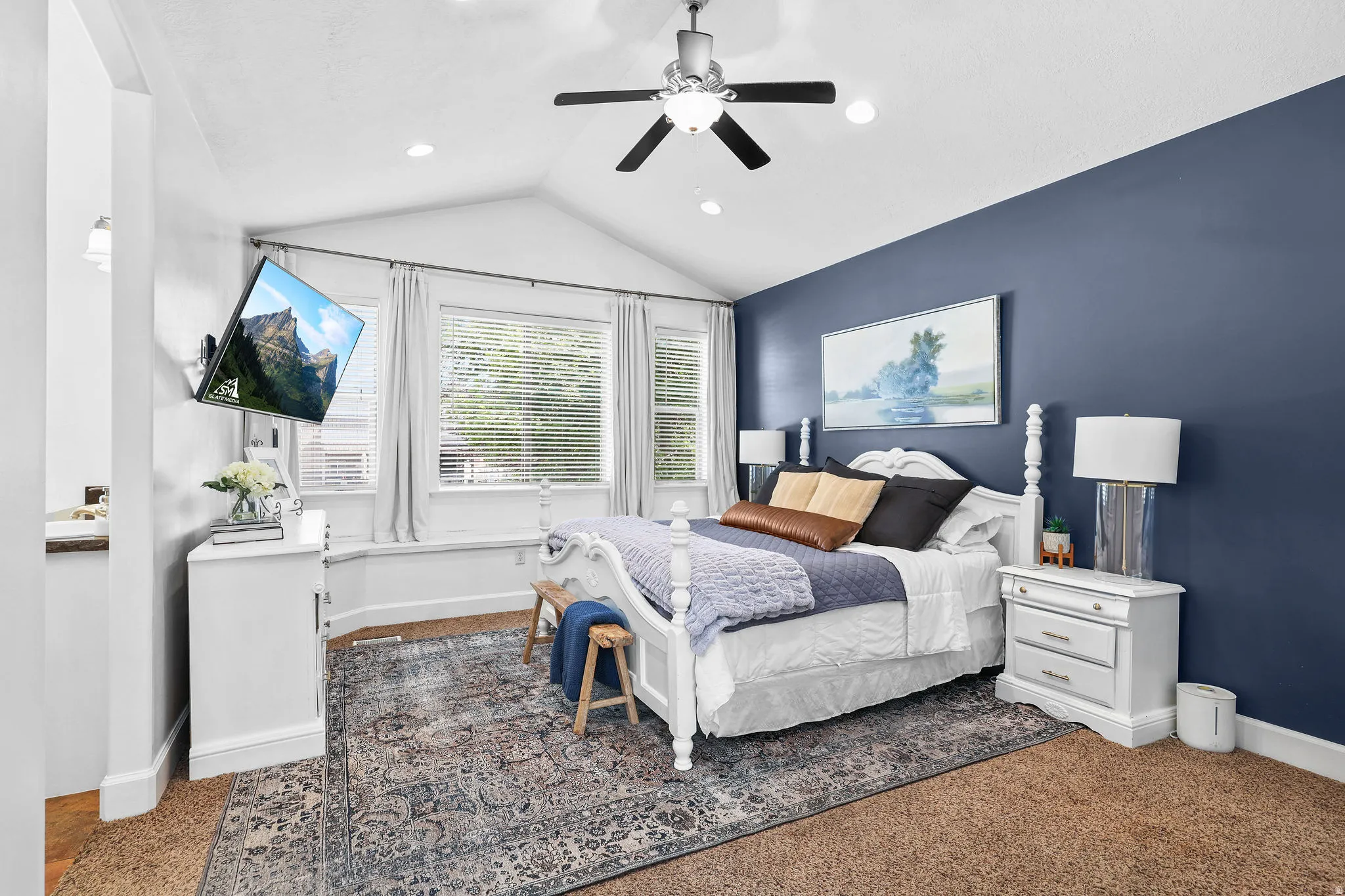 Vaulted ceiling with a ceiling fan and recessed lighting