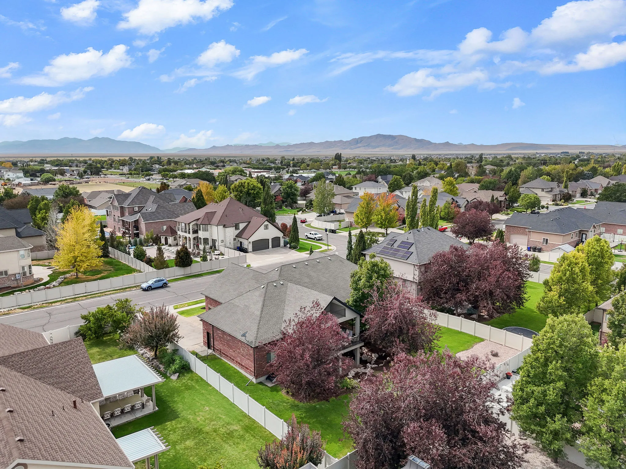 Residential area with mature trees and mountain scenery