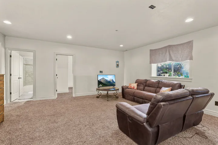 Recessed lighting, light-colored walls, window with natural light, and two interior doorways